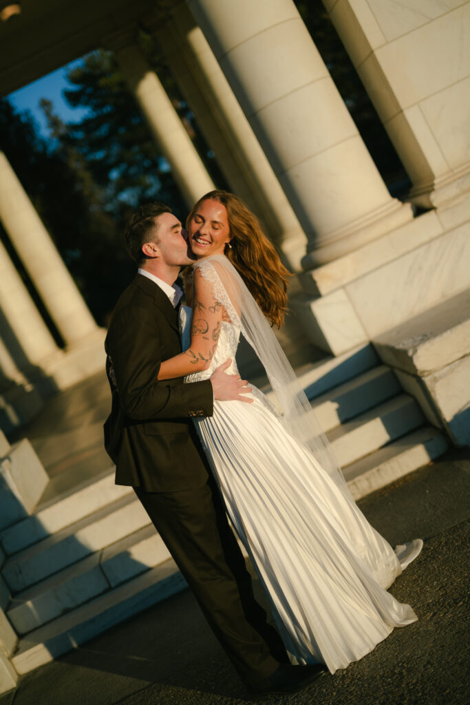 Bride and groom kissing and laughing