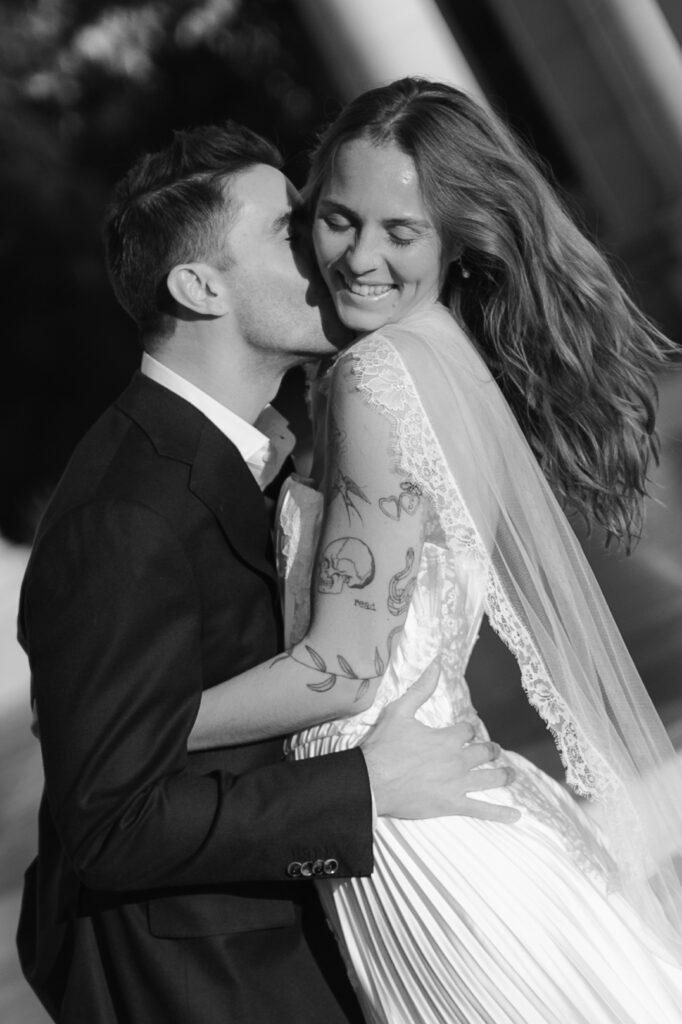 Bride and groom kissing together