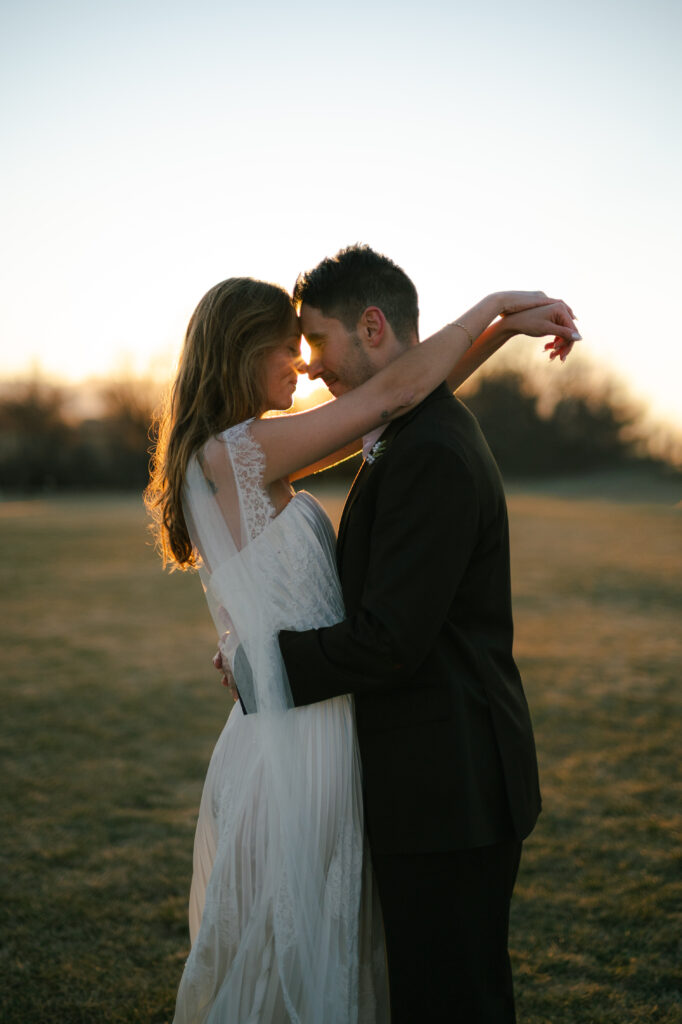 Bride and groom facing each other with eyes closed