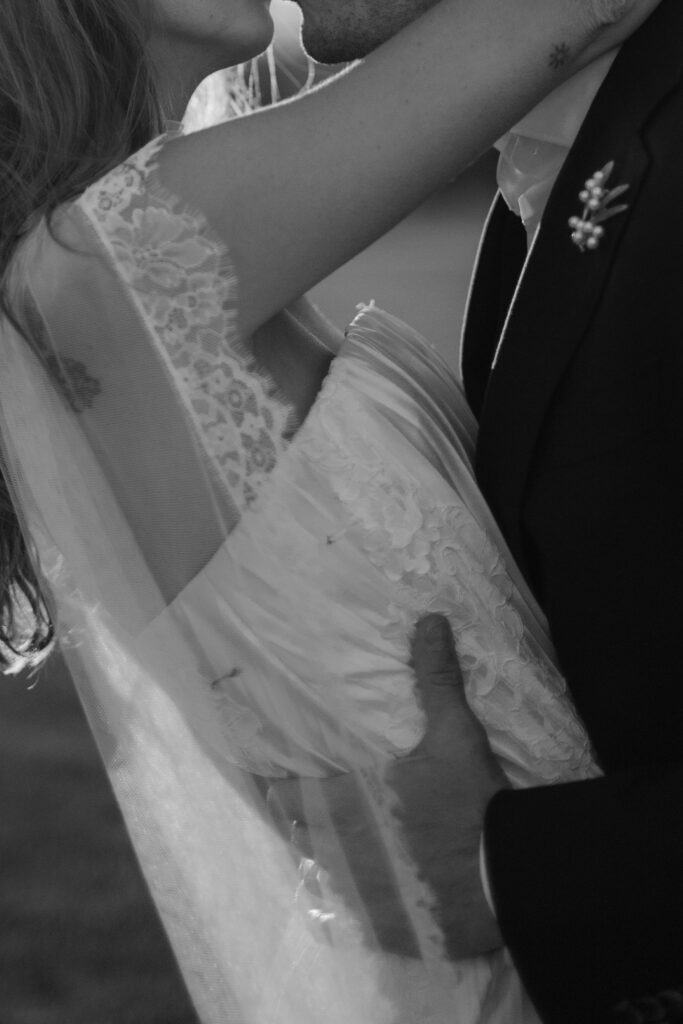 Bride and groom close up shot kissing in black and white